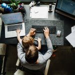 Mother Working In Office At Home With Daughter