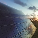 Solar panels field at sunset