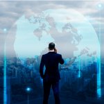 Businessman standing by on a rooftop overlooking the city