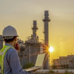 Young Electrician Man Looking Out Examine Power Plant Electricity Station Industrial Area