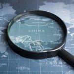 Magnifying glass on the world map.Business exploration system concept.