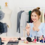 Beauty blogger present beauty cosmetics sitting in front camera