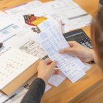 Financial owe asian woman, female sitting on floor home, stressed and confused by calculate expense from invoice or bill, have no money to pay, mortgage or loan. Debt, bankruptcy or bankrupt concept.