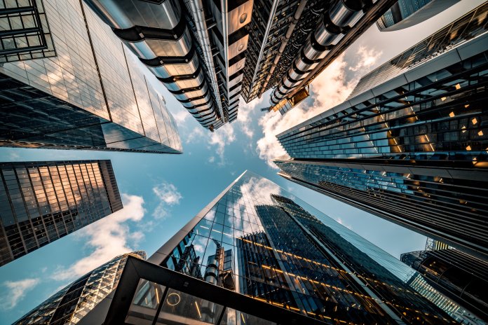 Looking directly up at the skyline of the financial district in central London - stock image ISO 27001 Cyber Resilience